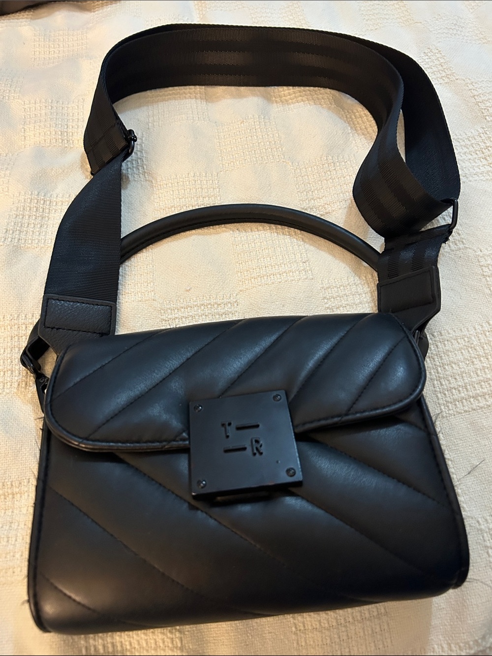 Think Royln bag features quilted chevron magnetic matte black hardware clasp.